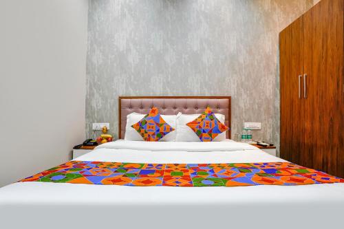 a bedroom with a large bed with a colorful comforter at FabExpress Affari in Mumbai