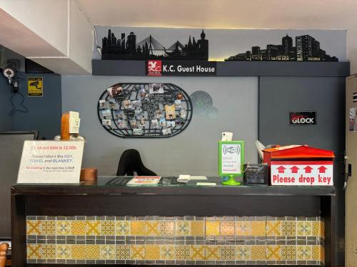 a counter in a fast food restaurant with a sign on the wall at KC guest house in Bangkok