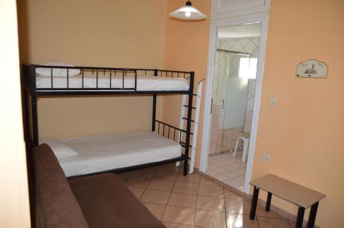 a room with two bunk beds and a table at Melia Studios in Kato Daratso