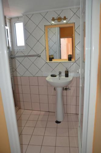 a bathroom with a sink and a mirror at Melia Studios in Kato Daratso
