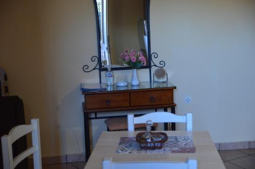 a dining table with a mirror on top of a dresser at Melia Studios in Kato Daratso