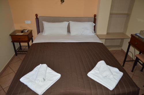 a bed with two white towels on top of it at Melia Studios in Kato Daratso
