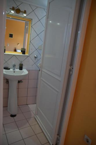 a bathroom with a sink and a shower with a mirror at Melia Studios in Kato Daratso