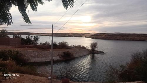 a view of a river with the sun setting at Amon guest house in Abu Simbel