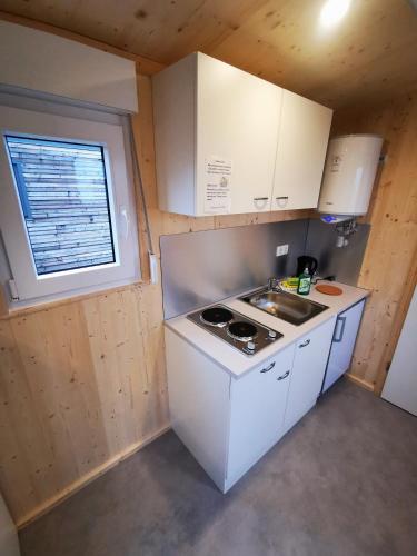 a small kitchen with a stove and a sink at Landhaus Herdt in Lauda-Königshofen