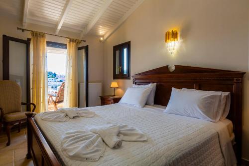 a bedroom with a bed with towels on it at Solaris Methea Deluxe Suites in Kassiopi