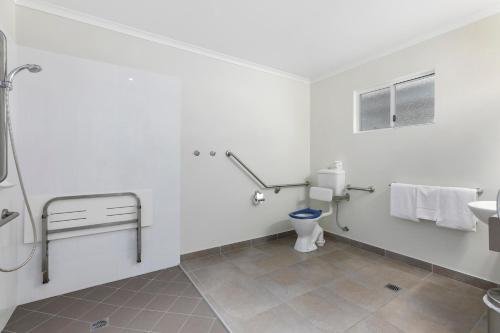 a bathroom with a toilet and a sink at Beachside Boutique Motel Mackay in Mackay