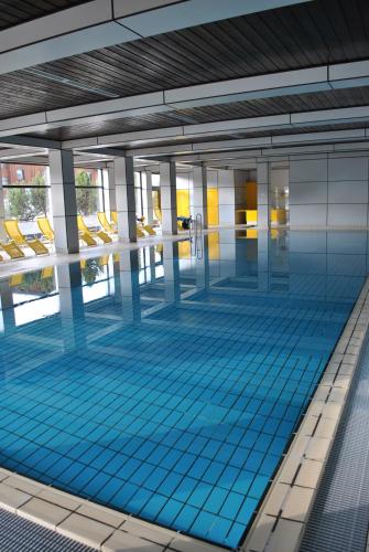 a swimming pool with blue tiles in a building at Ferienwohnung Pichlarn in Aigen im Ennstal