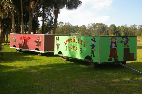 two food trucks parked on the grass in a field at Smugglers Cove Holiday Village in Forster