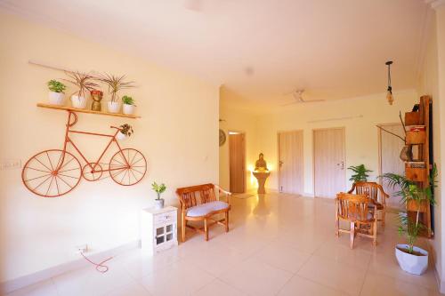 a living room with a bike hanging on the wall at Soul'Stay- A HomeStay & Retreat Center in Agra