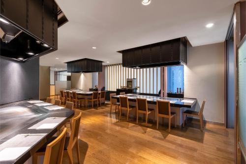 a kitchen and dining room with a table and chairs at ANA Crowne Plaza Kobe by IHG in Kobe