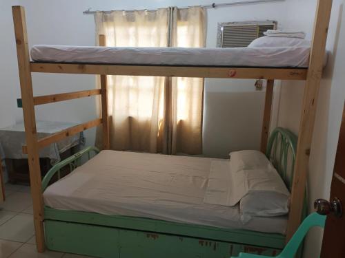 a bunk bed in a room with a bunk bedutenewayewayangering at Two-Hearts Dormitory in Dagupan