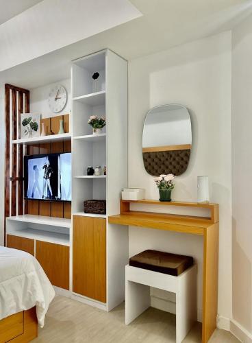 a bedroom with a dressing table and a mirror at Condo At Azure North San Fernado in San Fernando