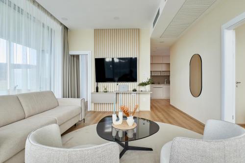 a living room with a couch and a table at Zala Springs Golf Resort in Zalacsány