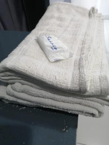 a pile of towels sitting on top of a table at Hotel Rim Global Pj21 in Kampong Baharu Sungai Way