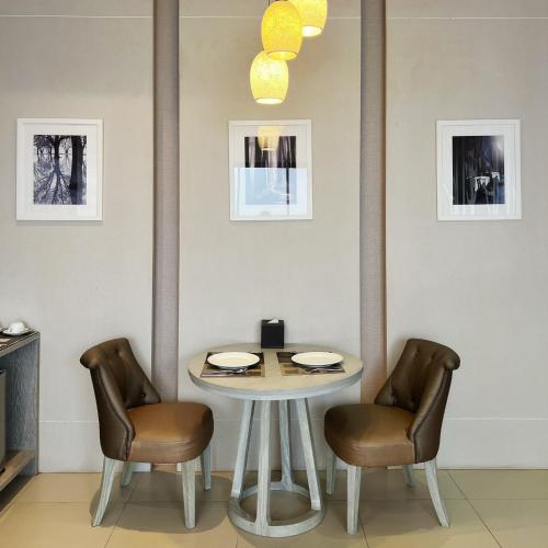 a table and two chairs in a room with a table at Cae Villa Hua Hin in Hua Hin
