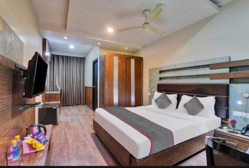 a hotel room with a bed and a television at HOTEL COSMOS in Bijnaur