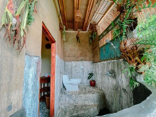 a bathroom with a toilet in a building at Bali Inang Jungle View in Tampaksiring