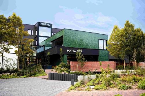 a view of the front of a point chef building at Porta Cité in Maasmechelen