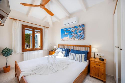 sypialnia z dużym białym łóżkiem i oknem w obiekcie Finca Son Macia w mieście Selva