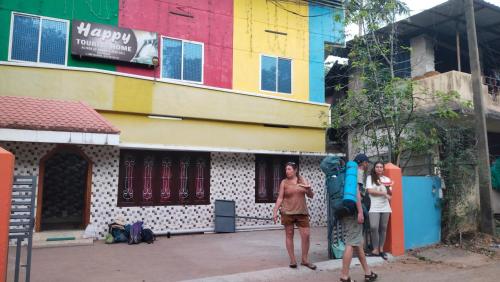 a group of people standing in front of a building at Happy Tourist Home and Dormitory Neyyardam in Parattipalli