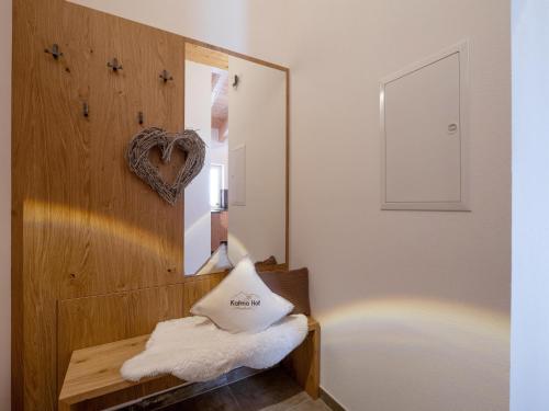 ein Spiegel an einer Wand neben einer Bank mit Handtüchern in der Unterkunft Appartements Kafmahof in Söll