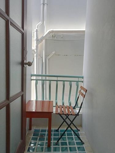 a chair sitting on a floor next to a door at Sripat Guesthouse SHA Extra Plus in Chiang Mai