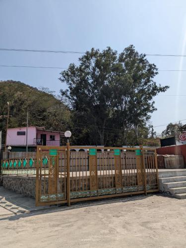 a wooden fence in front of a house at Blue Bell Homestay in Lonavala