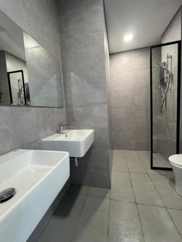 a bathroom with a sink and a tub and a toilet at Cubic Botanical KL Bangsar Entire Unit Parking/Pool in Kuala Lumpur