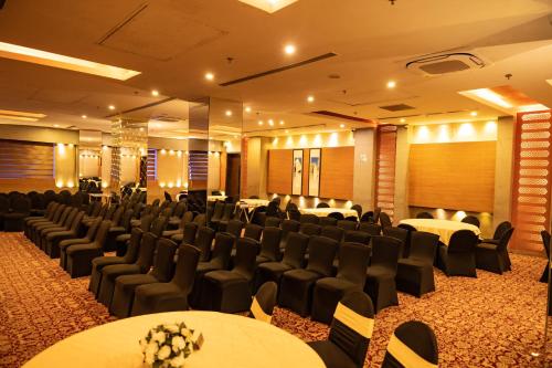 a conference room with tables and chairs in a building at Ramada Ajmer in Kishangarh