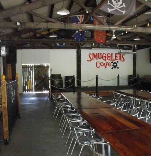 a room with chairs and a long wooden table at Smugglers Cove Holiday Village in Forster