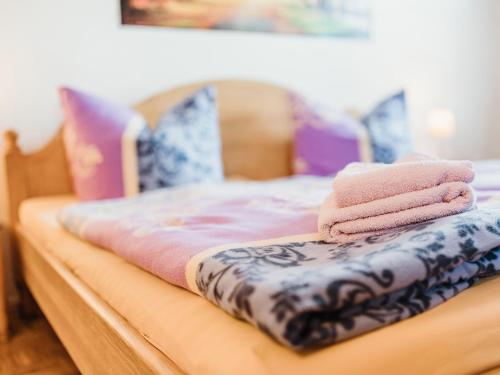 a bed with three folded towels on it at REBENTISCH - HOTEL Ferienwohnungen Restaurant in Hasselfelde