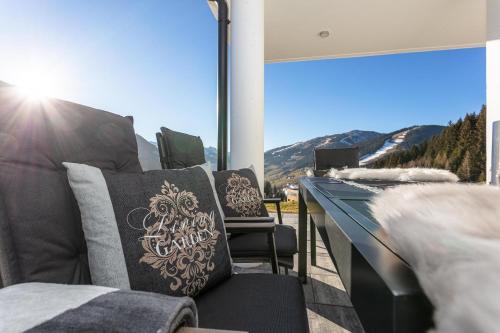 a balcony with chairs and a view of a mountain at Lienbichl in Saalbach Hinterglemm