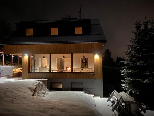 a house with lights in the windows at night at Chalet Dereše in Liptovský Mikuláš