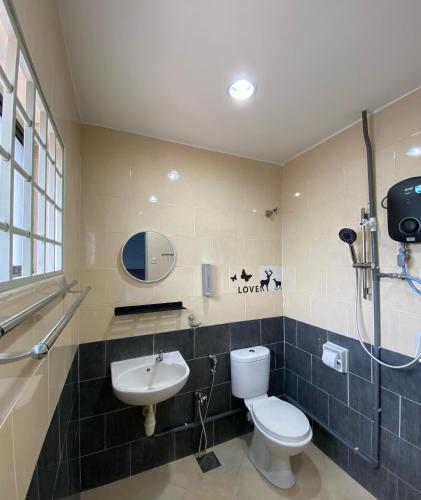a bathroom with a toilet and a sink at IPOH LYL EVERGREEN HOMESTAY 12pax in Ipoh