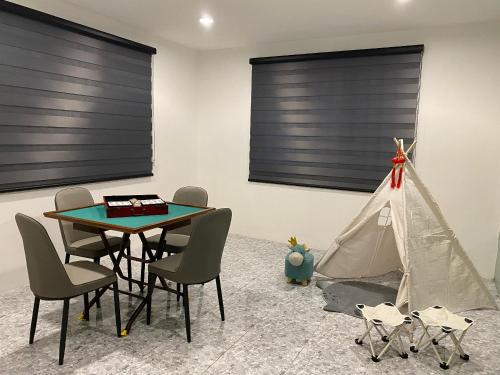 a dining room with a tent and a table and chairs at IPOH LYL EVERGREEN HOMESTAY in Ipoh