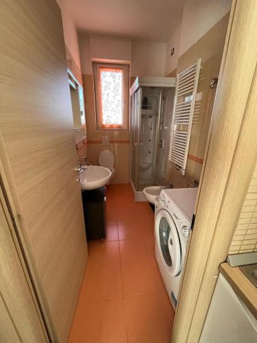 a bathroom with a sink and a washing machine at PARADISO INVERNO&ESTATE in Termoli