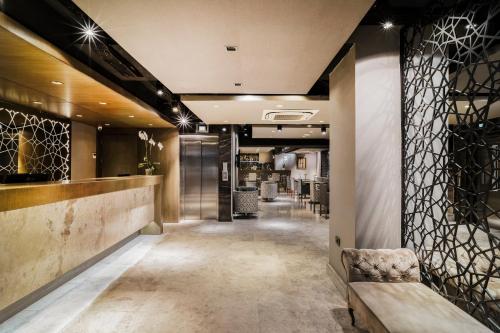 a lobby of a hotel with a bench and a bar at Grand Beyazit Hotel Old City in Istanbul