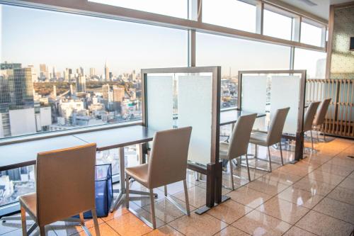 a conference room with a view of the city at Shibuya Excel Hotel Tokyu in Tokyo