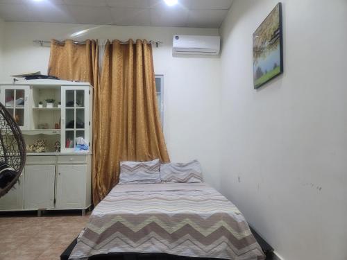 a small bedroom with a bed and a window at Sahal-House in Djibouti