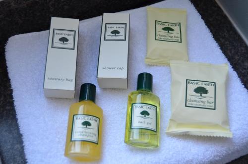 a group of four bottles of soap on a table at Devere Hotel in Sydney