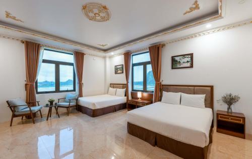 a hotel room with two beds and windows at Trang An International Hotel in Ninh Binh