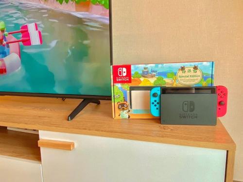 a tv sitting on top of a wooden cabinet at imperium residence kuantan in Kuantan