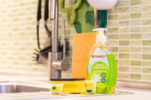 a bottle of cleaner sitting on a kitchen counter next to a sink at CaseOspitali - Casa Klimt, rinnovato bilocale in centro storico per 4 in Cernusco sul Naviglio