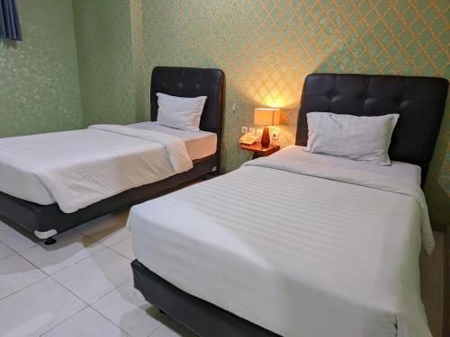 Hotel Nalendra Plaza Subangにあるベッド