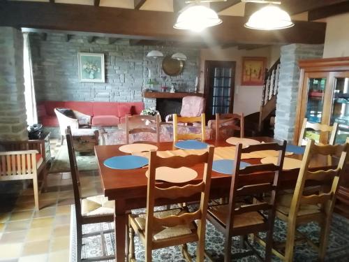 une salle à manger avec une table et des chaises en bois dans l'établissement logoden, à Paimpont