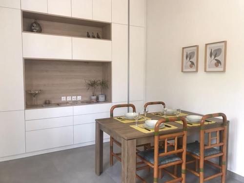 a dining room with a wooden table and chairs at New and spacious accommodation in Ioannina! in Ioannina
