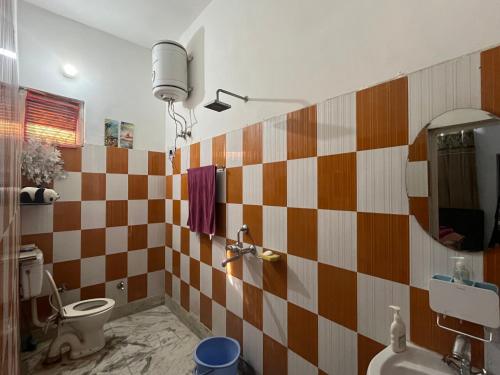 a bathroom with a sink and a toilet in it at Occasions in Jammu