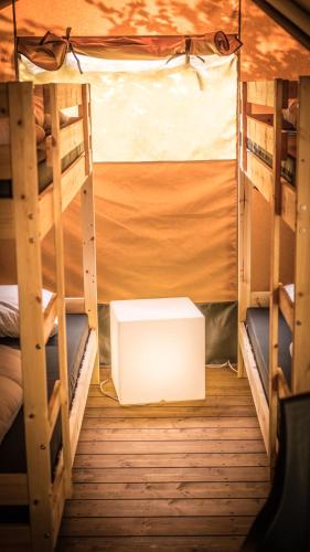 a room with two bunk beds and a white box at Safari Tent XL Camping Belle-Vue in Berdorf
