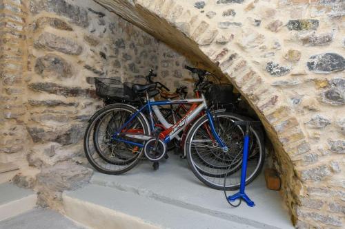 two bikes are parked in a stone wall at Casa Margherita - new house in the ancient hamlet in Salò